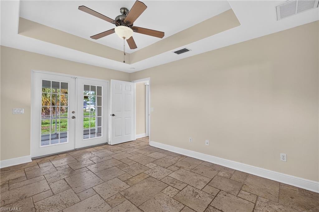 Master bedroom with lanai beyond French doors and dining room to right
