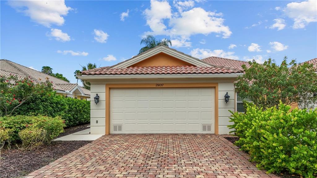 Mediterranean-inspired exterior with a tile roof and stucco siding