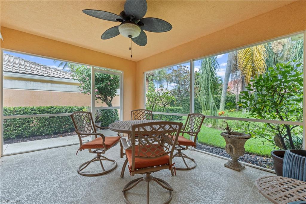 Screened patio featuring a ceiling fan, textured ceiling, and tile flooring