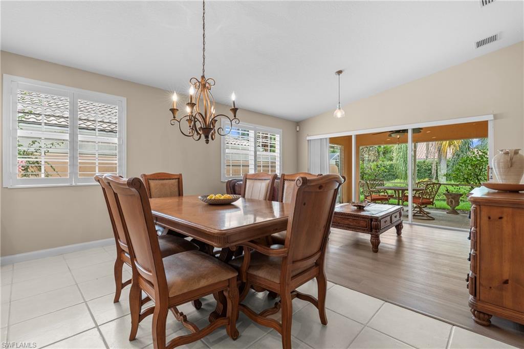 Dining area featuring a decorative chandelier and white plantation shutters