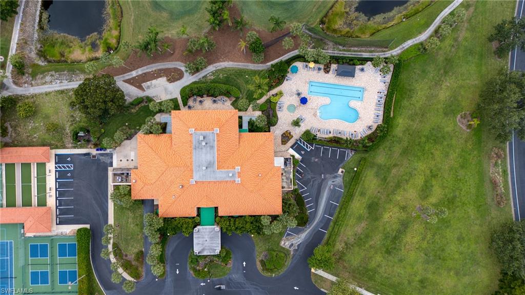 Expansive property featuring a large building with a terracotta tile roof, multiple tennis courts, several pickleball courts, and a resort-style swimming pool with a sun deck