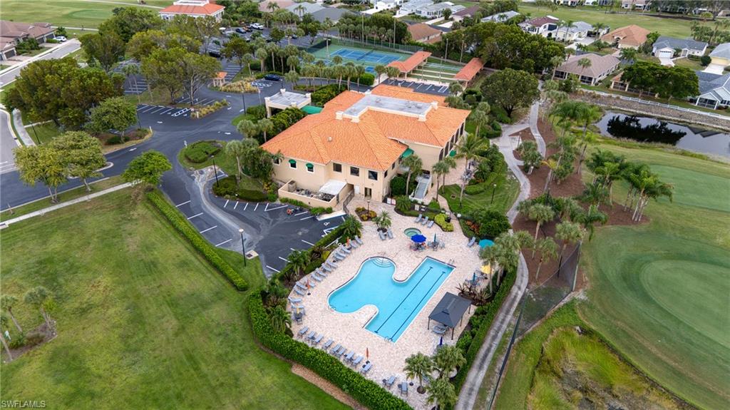 Expansive recreation facility featuring a large swimming pool, tennis courts, and bocce ball courts
