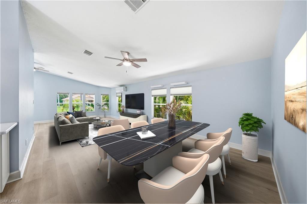 Expansive living and dining areas featuring vaulted ceilings, wood-finish flooring, and multiple windows