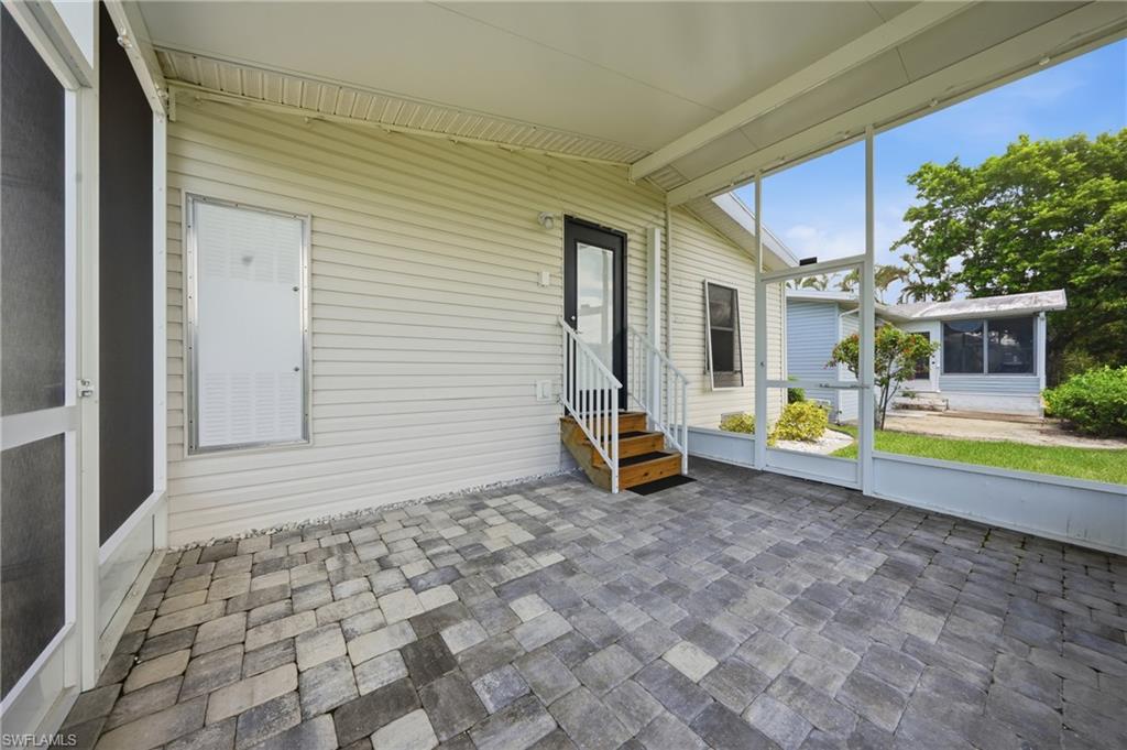 Screened patio featuring multi-toned paver flooring