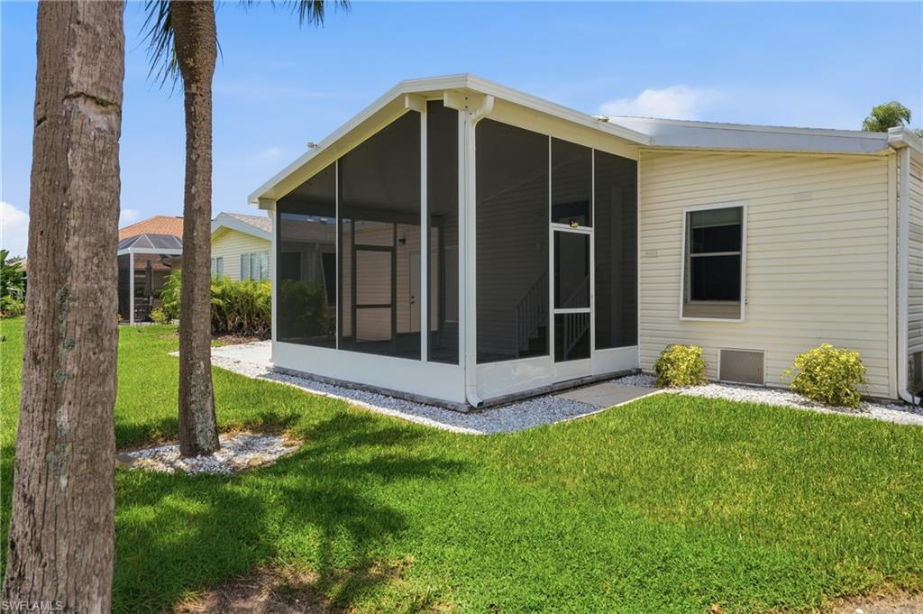 Exterior featuring a screened porch, light-colored siding, and white trim