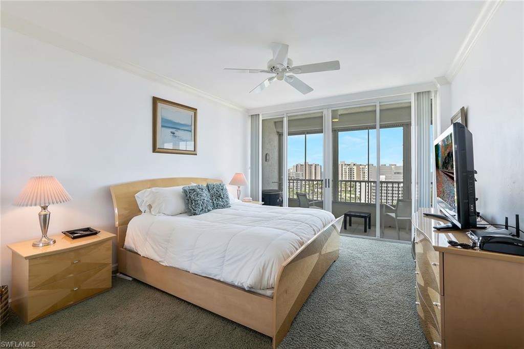 Carpeted bedroom featuring ornamental molding, access to outside, expansive windows, and ceiling fan