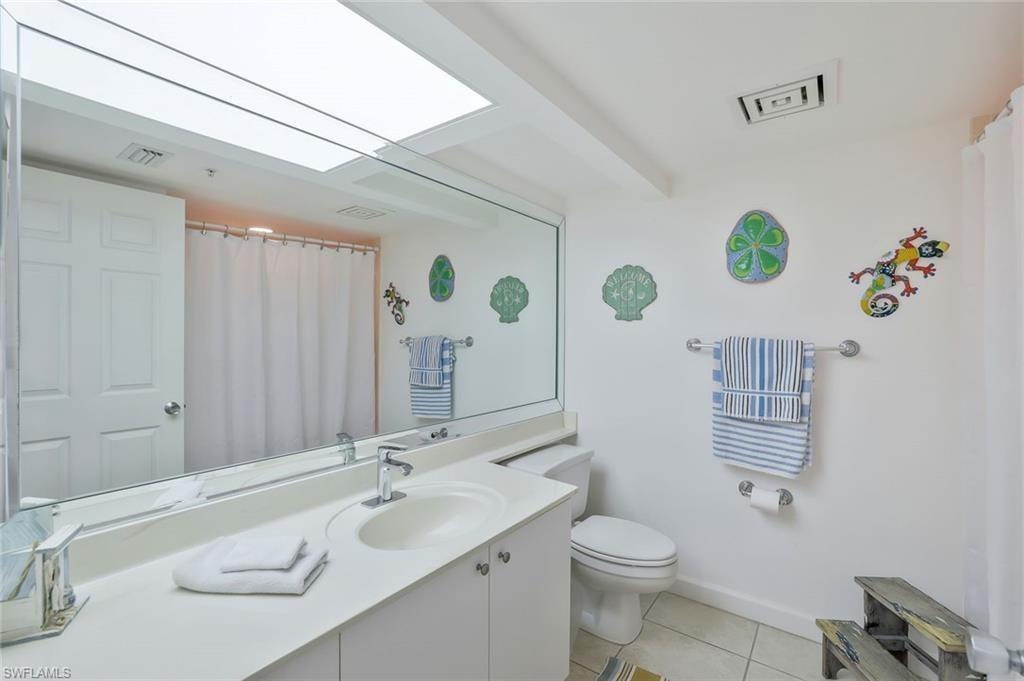 Full bath with vanity and tile patterned floors