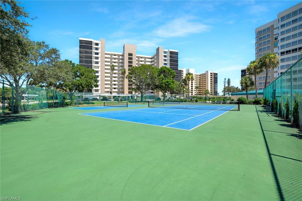 View of tennis court with a city view
