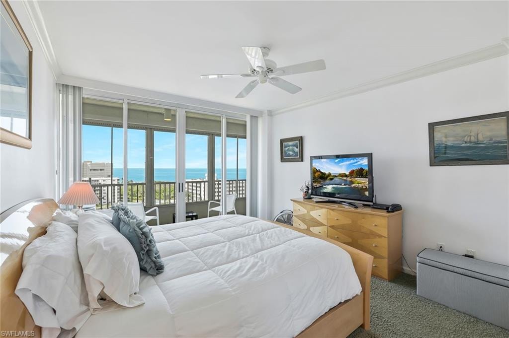 Bedroom featuring ornamental molding, access to exterior, carpet floors, ceiling fan, and expansive windows