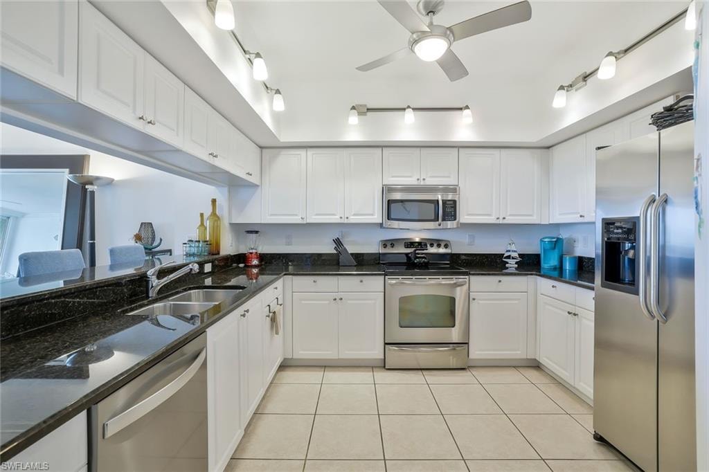 Kitchen featuring stainless steel appliances and white cabinetry