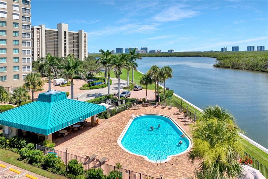 Community pool featuring a view of skyline and a water view