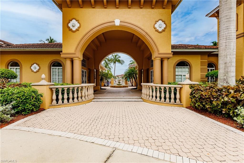 Community View of exterior entry with stucco siding and a tile roof