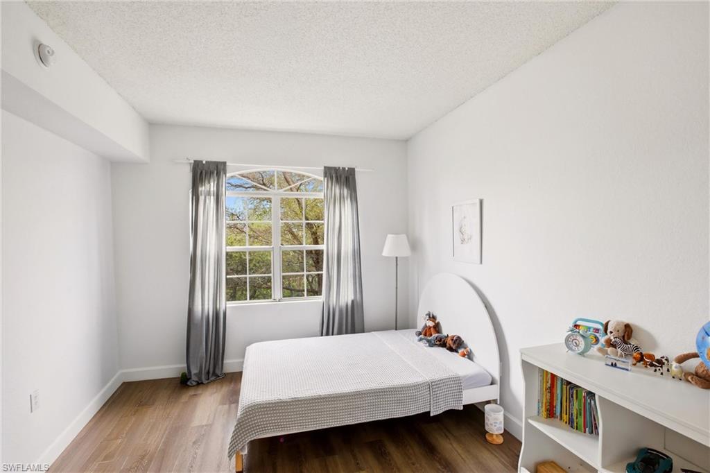 Bedroom featuring wood finished floors and a textured ceiling