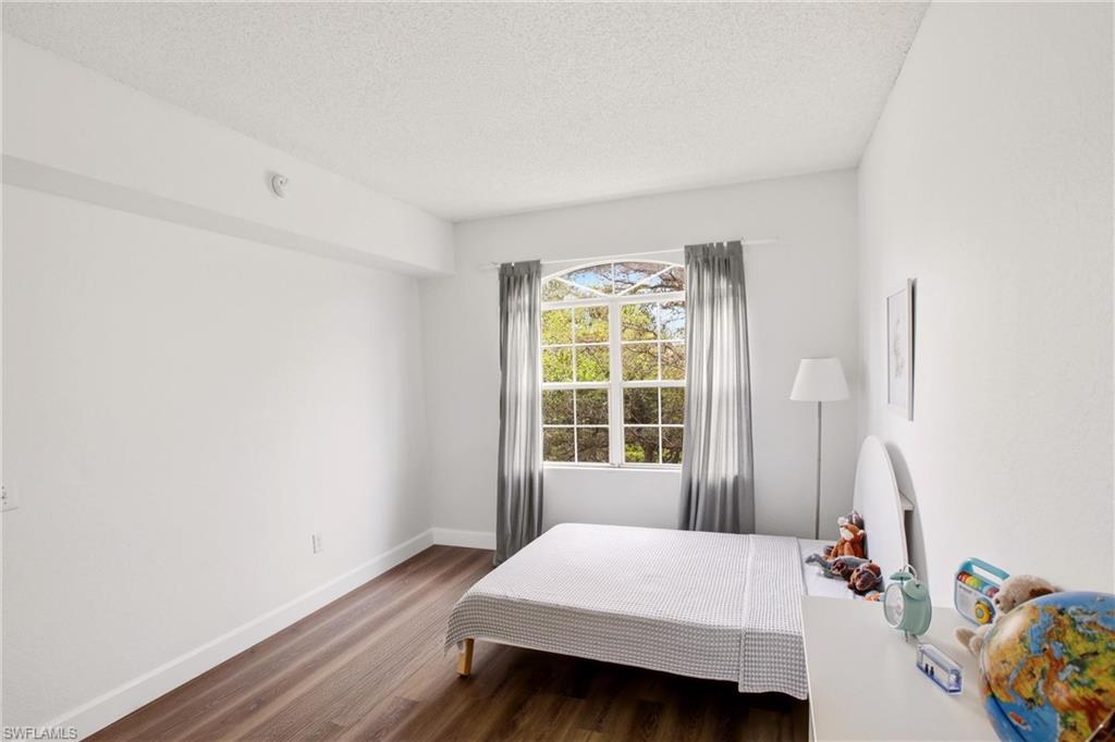 Bedroom featuring dark wood finished floors and a textured ceiling