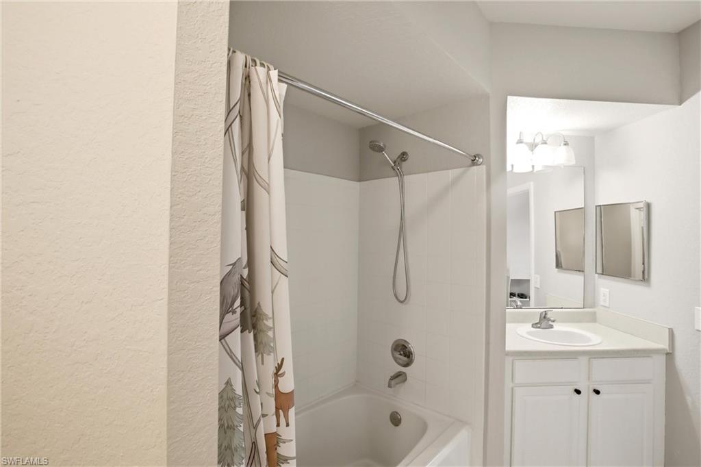 Bathroom with vanity and shower / bath combo