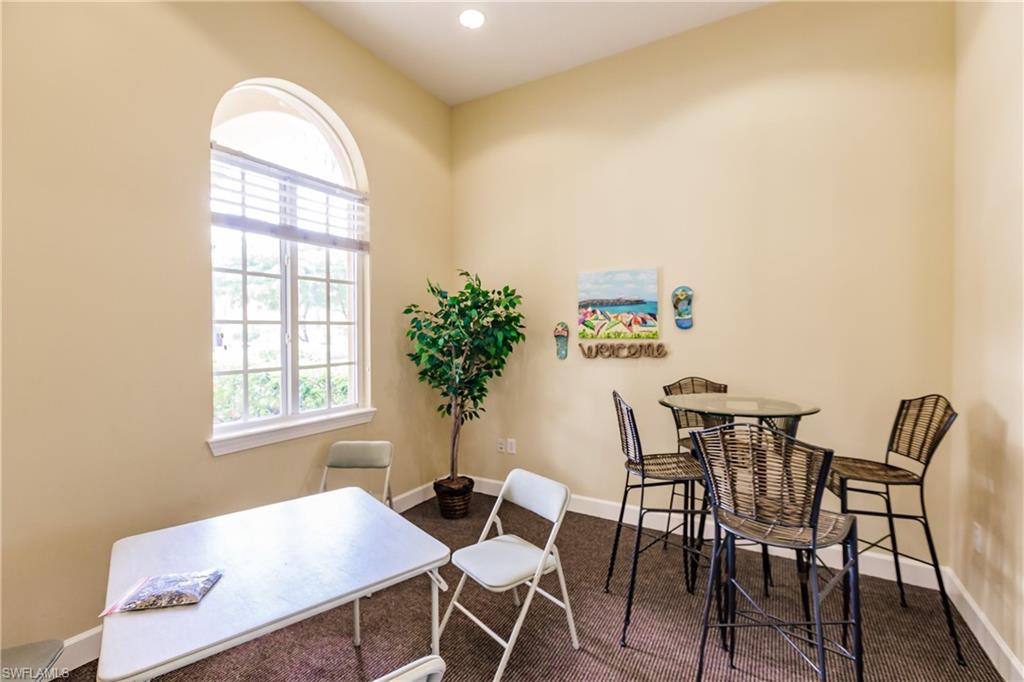 Office area featuring dark colored carpet and recessed lighting