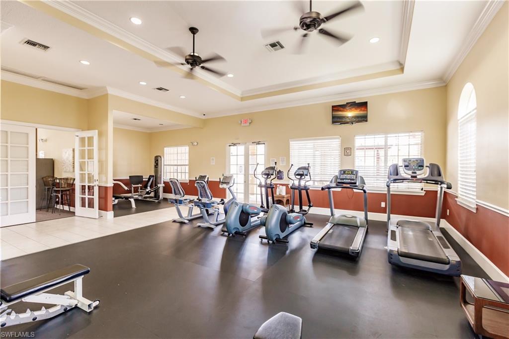 Workout area with french doors, ceiling fan, and crown molding
