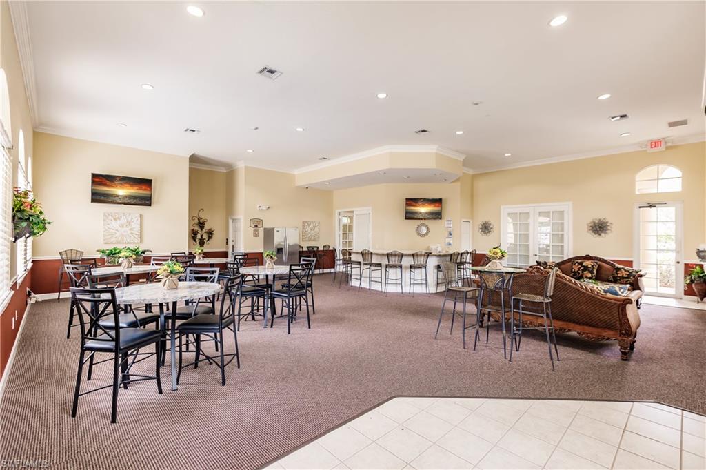 Dining space with light colored carpet, crown molding, recessed lighting, and light tile patterned flooring