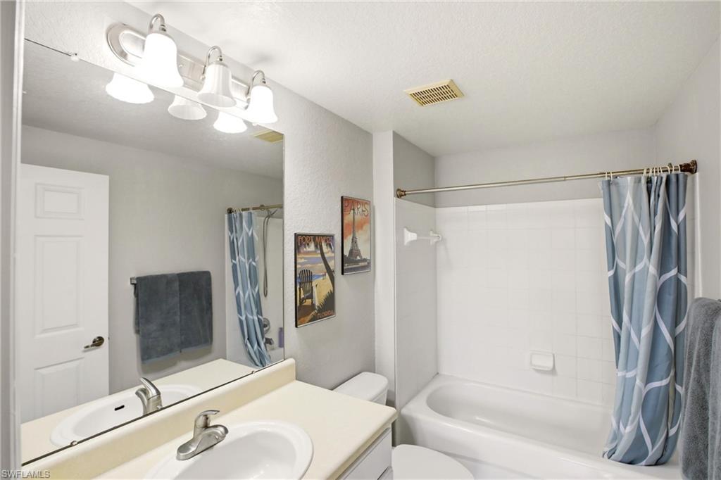 Bathroom with vanity and shower / tub combo