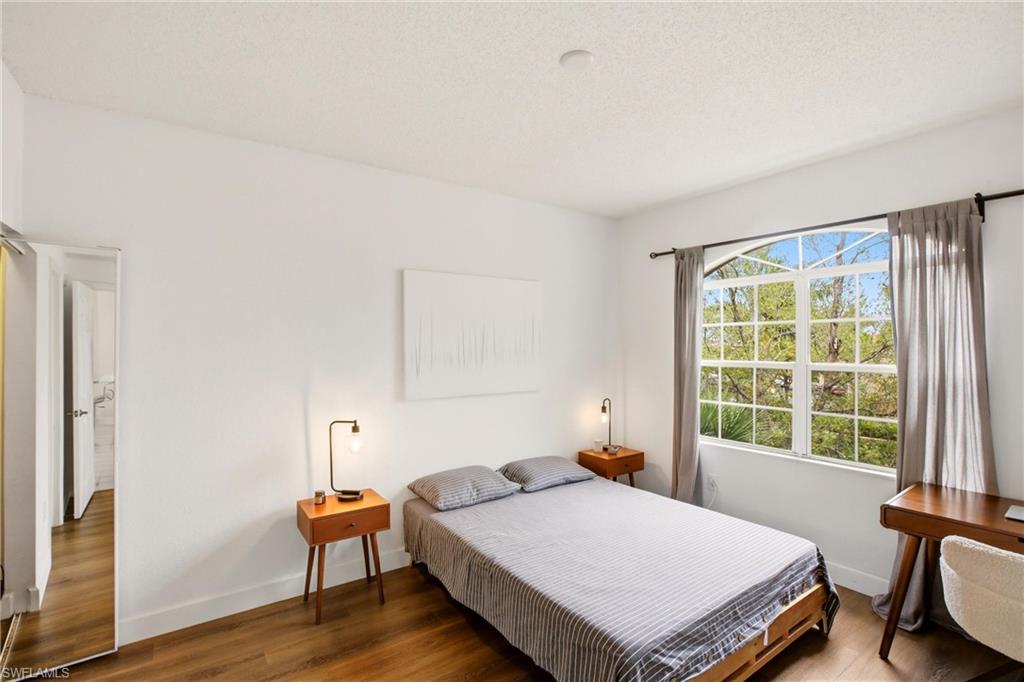 Bedroom featuring wood finished floors and a textured ceiling