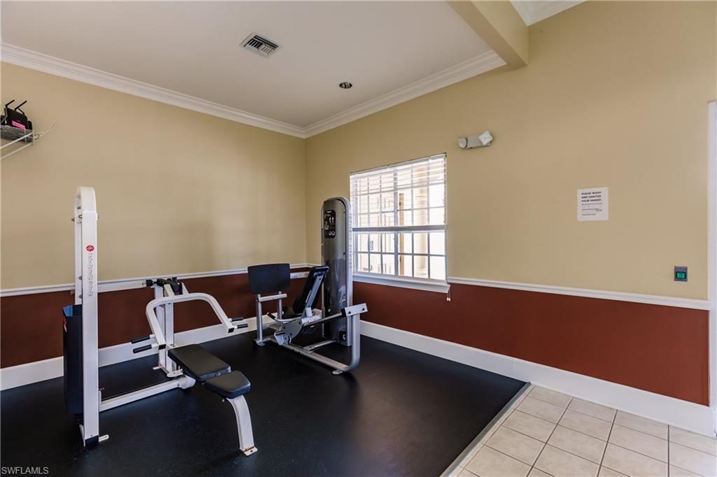 Workout room featuring ornamental molding