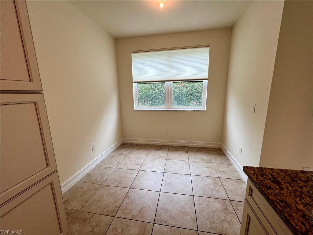 Unfurnished dining area with light tile patterned flooring