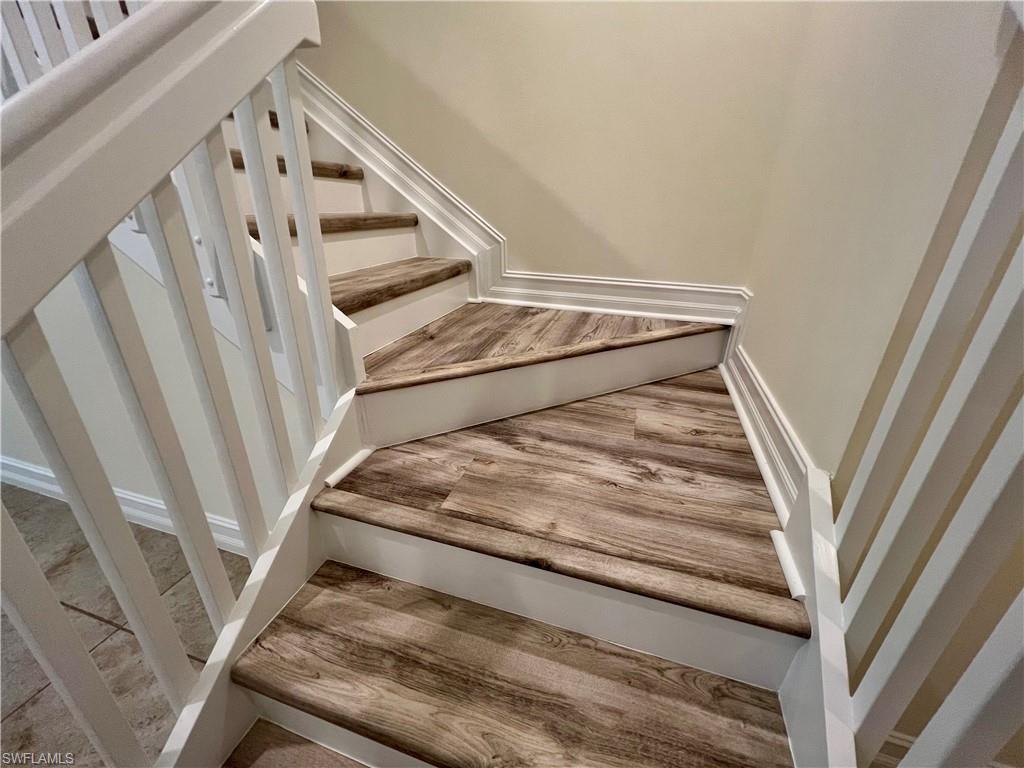 Stairs featuring Luxury vinyl plank / wood-style floors