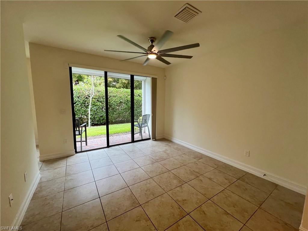 Tiled empty room with ceiling fan
