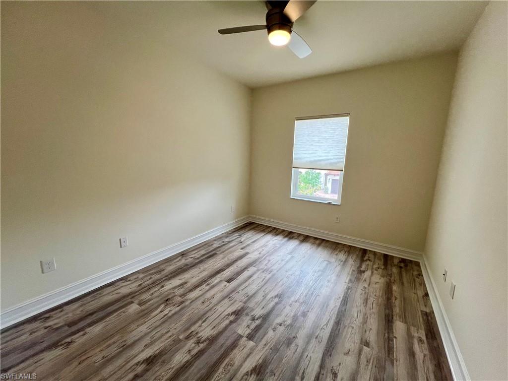 Unfurnished room featuring Luxury Vinyl Plank / wood-style flooring and ceiling fan