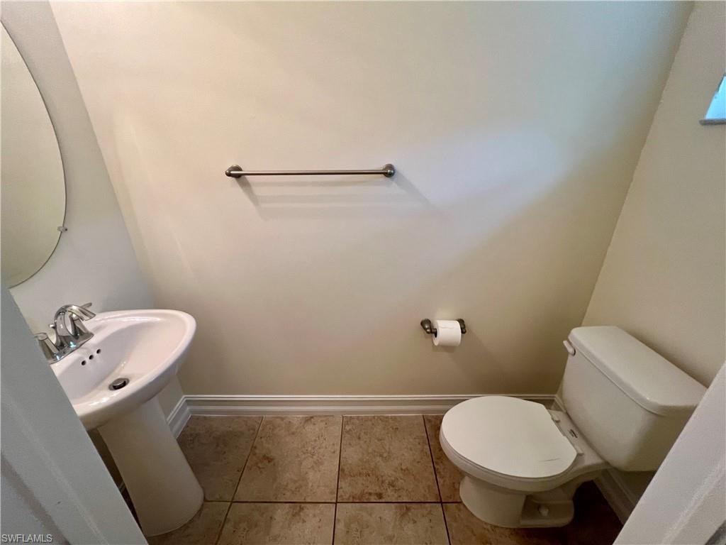 Bathroom with tile patterned flooring and toilet