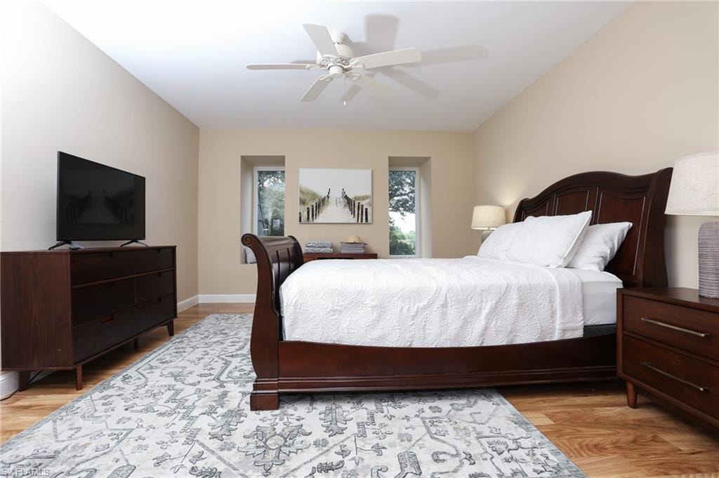 Bedroom with ceiling fan and light wood finished floors