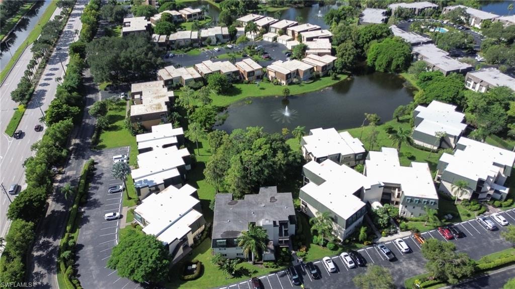 Drone / aerial view with a water view and a residential view