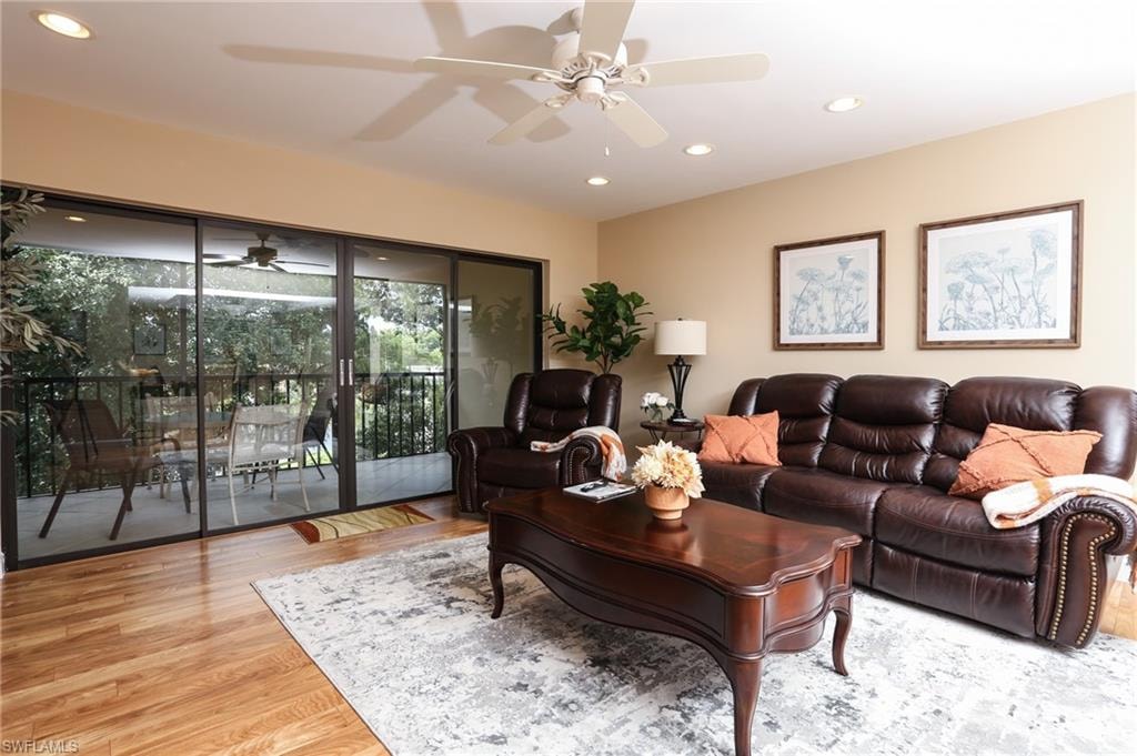 Living room with ceiling fan, wood finished floors, and recessed lighting