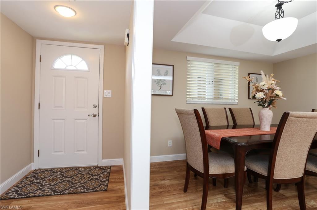 Foyer entrance featuring light wood-type flooring and baseboards