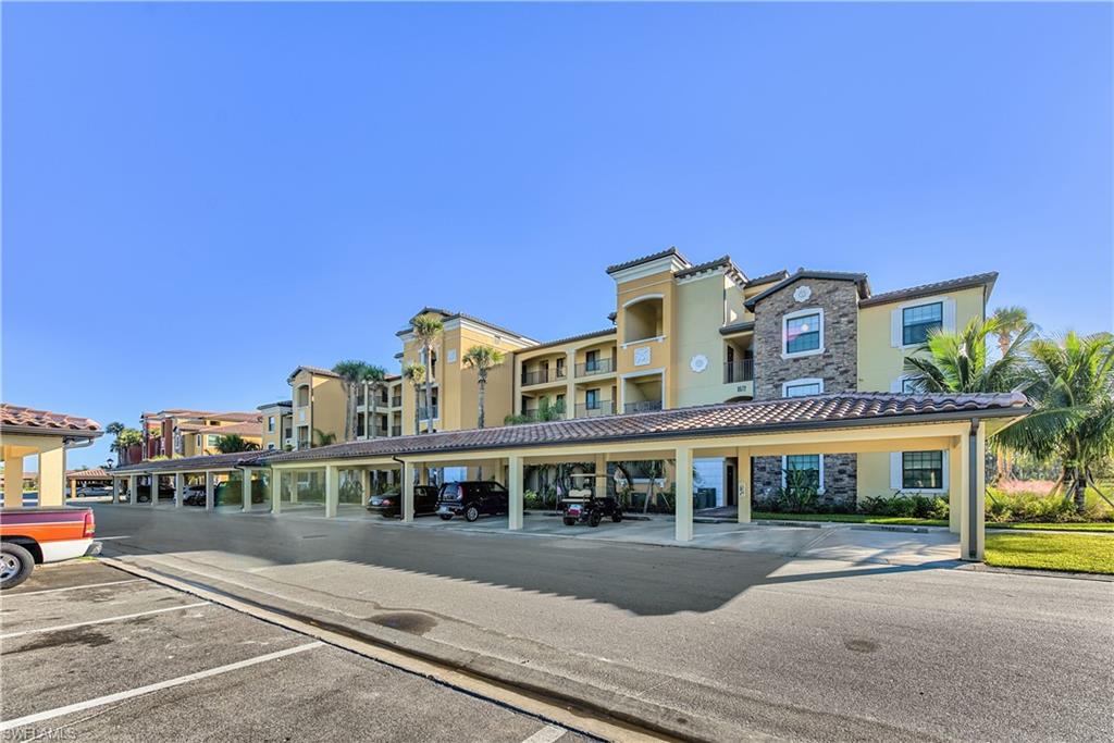 Multi-story residential building with stucco and stone exterior finishes