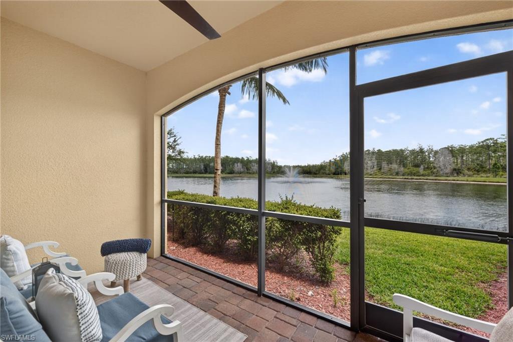 Screened lanai featuring brick-finish flooring and a ceiling fan