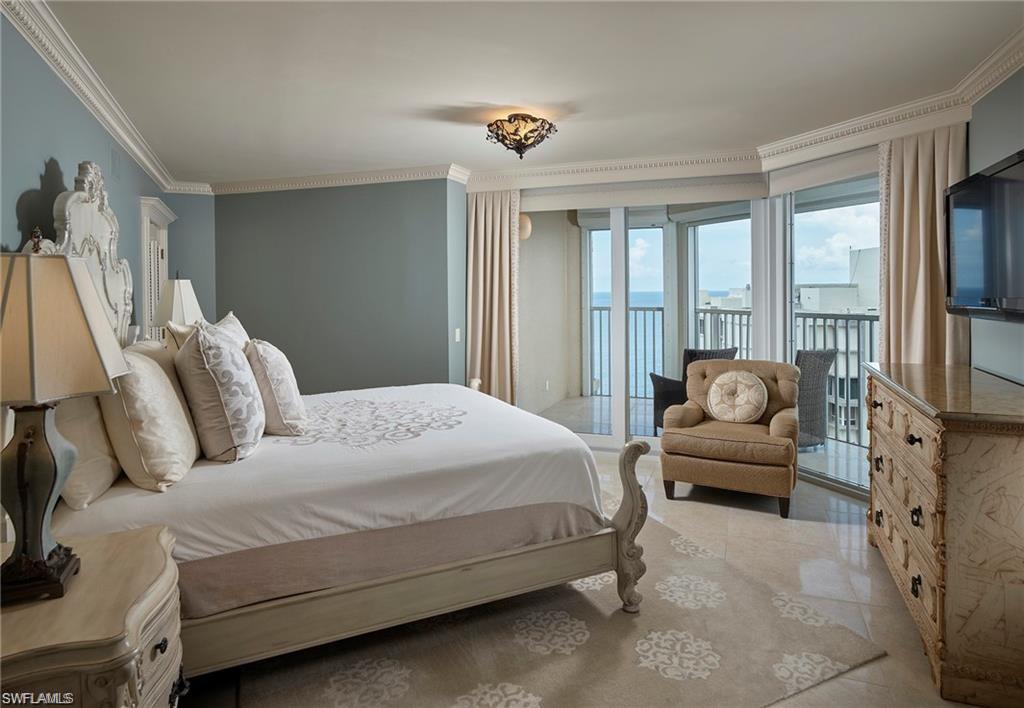 Tiled bedroom with ornamental molding and access to exterior