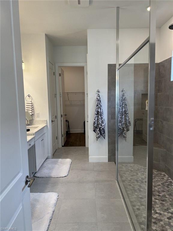 Contemporary bathroom featuring a spacious glass-enclosed shower with mosaic hexagonal tile flooring and a built-in bench