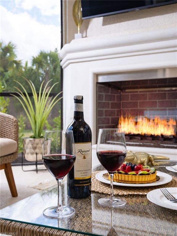 Outdoor fireplace featuring a stone mantel and brick firebox