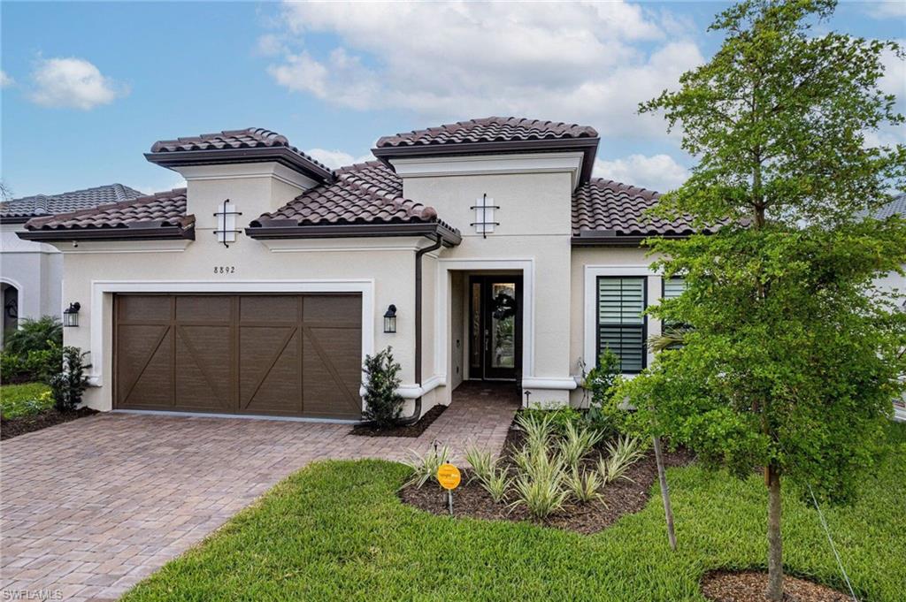 Mediterranean-inspired exterior featuring a tile roof and stucco finish