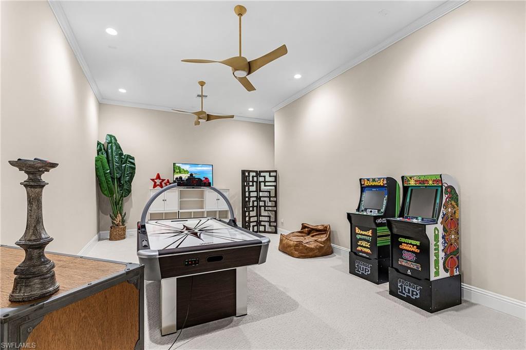 Spacious room featuring neutral carpeting, recessed lighting, and crown molding