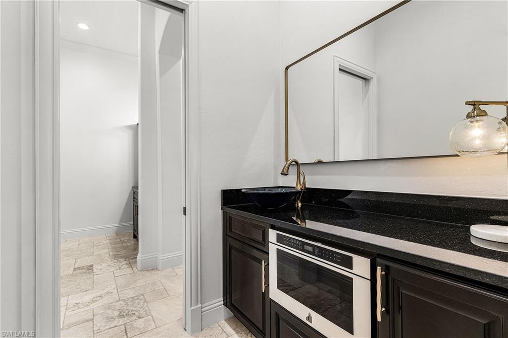 Space in between primary baths, completes with  microwave and fridge