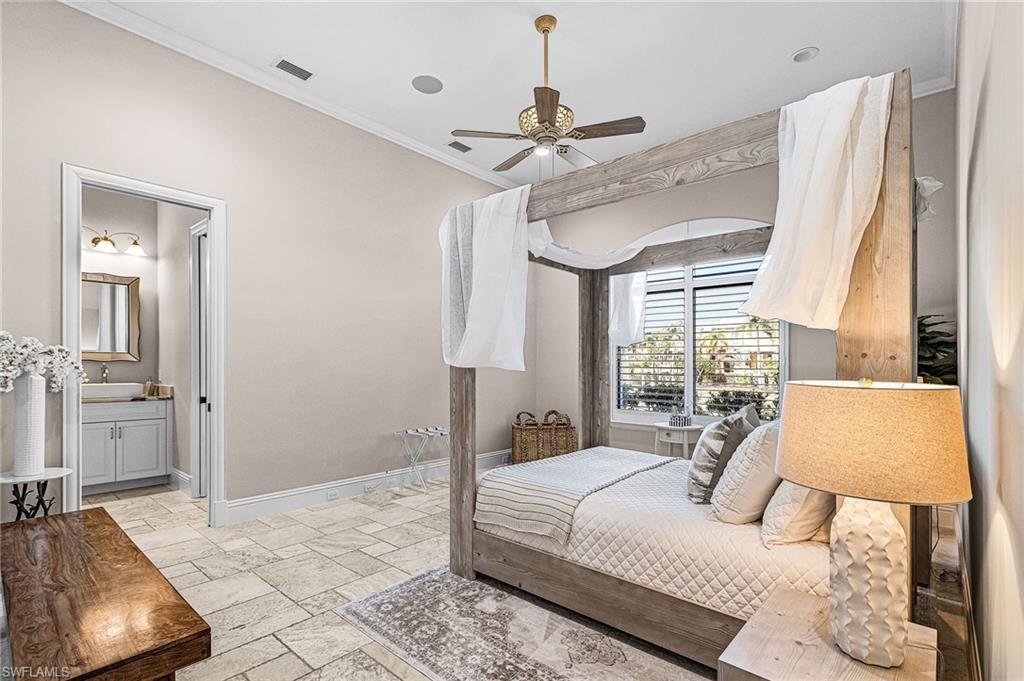 Bedroom featuring light tile flooring, crown molding, and a ceiling fan with integrated lighting