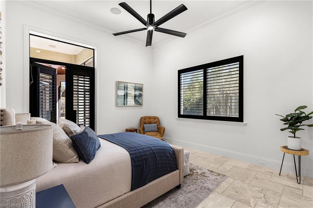 High ceilings with crown molding and a contemporary ceiling fan