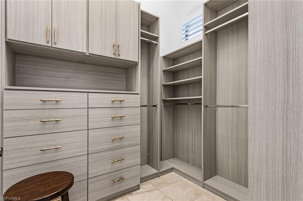 Custom closet system featuring light wood-finish cabinetry