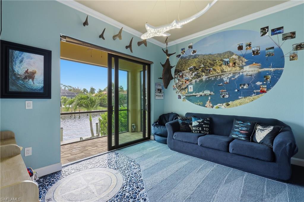 Play room. Sliding glass doors open to a screened porch, offering waterfront views