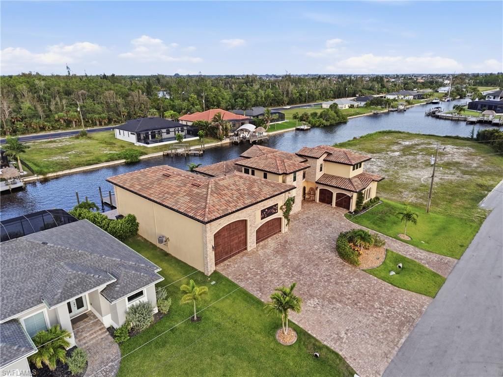 Mediterranean-style residence featuring a tile roof and stucco exterior