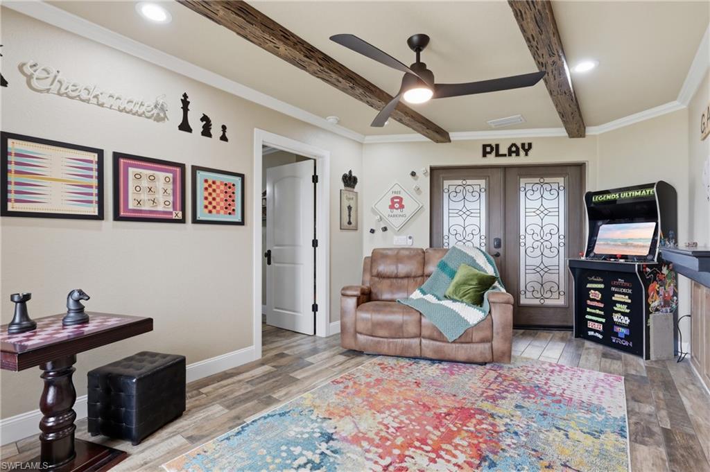 Room featuring wood-finish flooring, recessed lighting, and a ceiling fan with integrated light