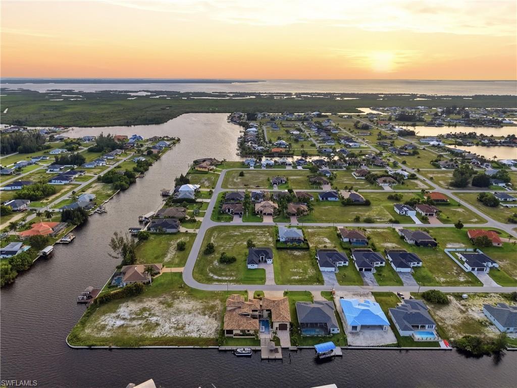 Aerial panorama of a residential canal-front community with numerous properties featuring private boat docks