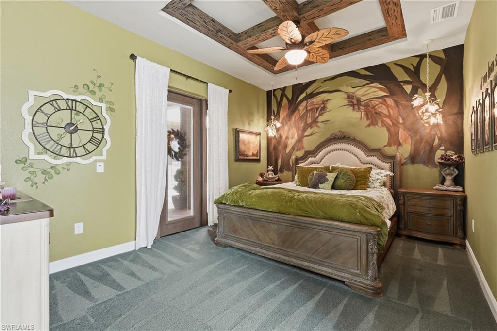 Recessed ceiling with wood-beam detailing, a decorative ceiling fan, and a light-toned wood-finish bed frame with an upholstered headboard